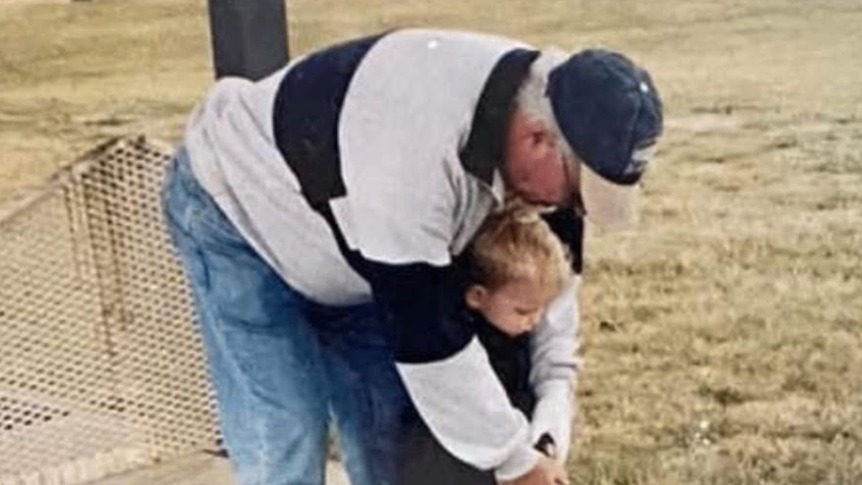 Harry Kenneth Fritz with his grandson on the green at Pawleys Island — a lifetime of early mornings, distilled.