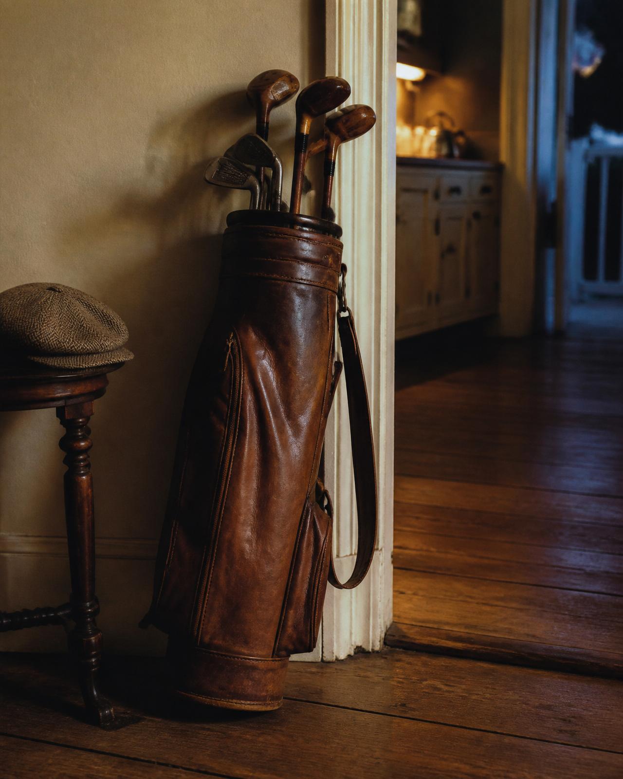 A vintage leather grip resting by the kitchen door before dawn.